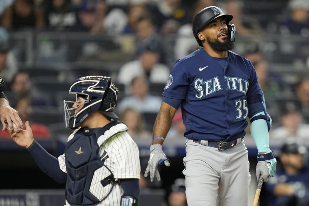Seattle Mariners' Teoscar Hernandez (35) reacts to a swinging strike against New York Yankees relief pitcher Clay Holmes in the ninth inning of a baseball game, Tuesday, June 20, 2023, in New York. (AP Photo/John Minchillo)