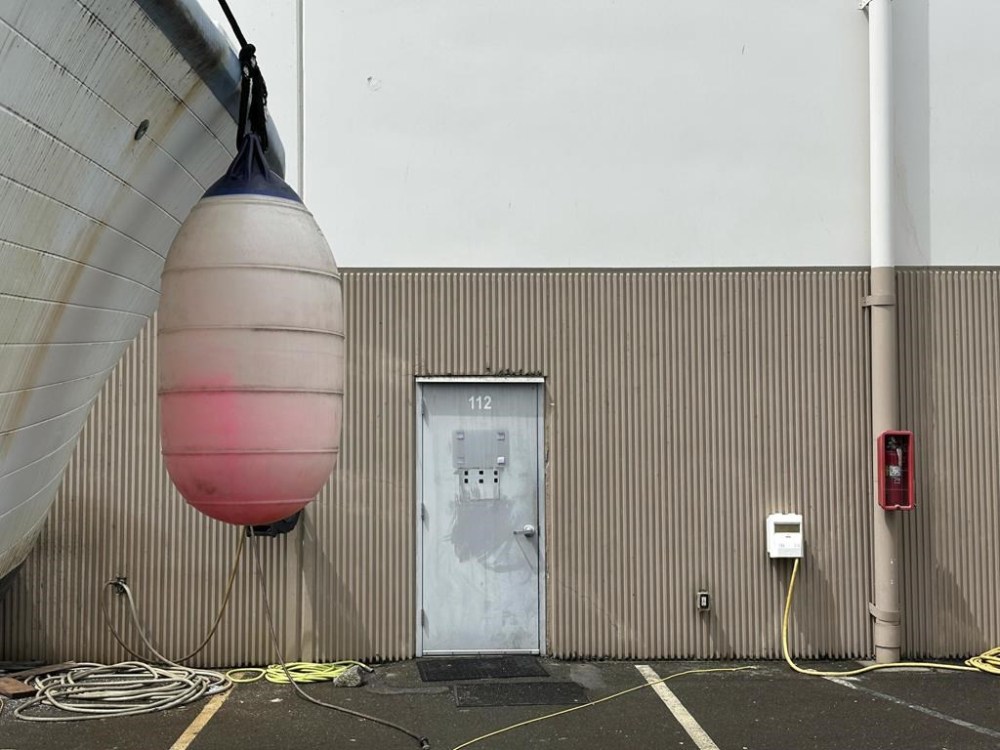 A boat is parked outside the back entrance to the OceanGate Expeditions office in a marine industrial warehouse office door in Everett, Wash., Tuesday, June 20, 2023. Rescuers raced against time to find the missing submersible carrying five people, who were reported overdue Sunday night. (AP Photo/Ed Komenda)