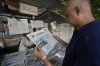 A man reads a copy of a morning newspaper which reports missing Titanic submersible and onboard five people, including Pakistani nationals Shahzada Dawood and his son Suleman, at a stall, in Karachi, Pakistan, Wednesday, June 21, 2023. A Canadian military surveillance aircraft detected underwater noises as a massive operation searched early Wednesday in a remote part of the North Atlantic for the submersible that vanished while taking five people down including Dawood, a well-known Pakistani businessman and his 19-year-old son to the wreck of the Titanic. (AP Photo/Fareed Khan)