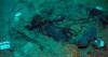 FILE - This 2004 photo provided by the Institute for Exploration, Center for Archaeological Oceanography/University of Rhode Island/NOAA Office of Ocean Exploration, shows the remains of a coat and boots in the mud on the sea bed near the Titanic's stern. Rescuers are racing against time to find the missing submersible carrying five people, who were reported overdue Sunday night, June 18, 2023. (Institute for Exploration, Center for Archaeological Oceanography/University of Rhode Island/NOAA Office of Ocean Exploration, File)
