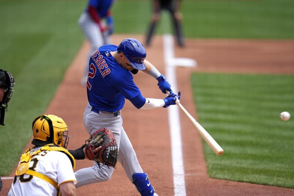 Chicago Cubs' Nico Hoerner hits a triple off Pittsburgh Pirates starting pitcher Rich Hill, driving in two runs, during the third inning of a baseball game in Pittsburgh, Wednesday, June 21, 2023. (AP Photo/Gene J. Puskar)