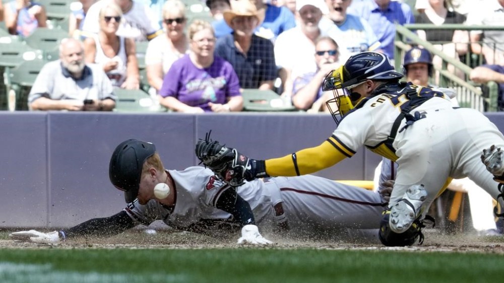 Arizona Diamondbacks' Pavin Smith scores as Milwaukee Brewers' William Contreras can't hold on to the ball during the sixth inning of a baseball game Wednesday, June 21, 2023, in Milwaukee. (AP Photo/Morry Gash)