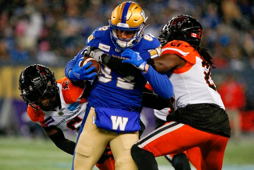 Winnipeg Blue Bombers' Drew Wolitarsky (82) gets tackled by BC Lions' T.J. Lee (6) and Jordan Williams (21) during the second half of CFL western final action in Winnipeg, Sunday, Nov. 13, 2022. Wolitarsky is confident the Blue Bombers won’t be shut out by the visiting B.C. Lions on Thursday. THE CANADIAN PRESS/John Woods