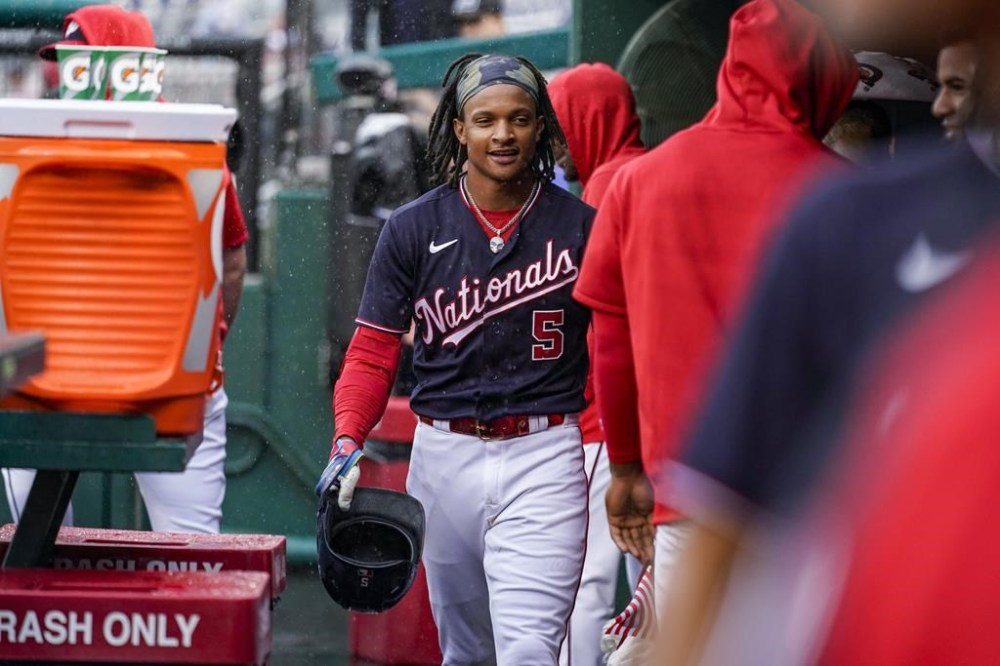Washington Nationals CJ Abrams walks through the dugout after hitting a solo home run in the rain during the fifth inning of a baseball game against the St. Louis Cardinals at Nationals Park, Wednesday, June 21, 2023, in Washington. (AP Photo/Andrew Harnik)