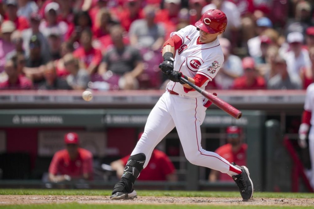 Cincinnati Reds' TJ Friedl hits an RBI-single during the fifth inning of a baseball game against the Colorado Rockies in Cincinnati, Wednesday, June 21, 2023. (AP Photo/Aaron Doster)