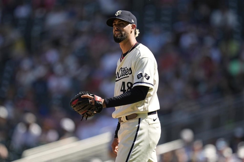 Minnesota Twins relief pitcher Jorge Lopez reacts after a two-run home run by Toronto Blue Jays' Daulton Varsho during the ninth inning of a baseball game Saturday, May 27, 2023, in Minneapolis. (AP Photo/Abbie Parr)