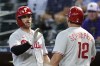 Philadelphia Phillies' Kyle Schwarber (12) gets a high-five from Bryce Harper after Schwarber hit a home run against the Arizona Diamondbacks during the first inning of a baseball game Tuesday, June 13, 2023, in Phoenix. (AP Photo/Ross D. Franklin)