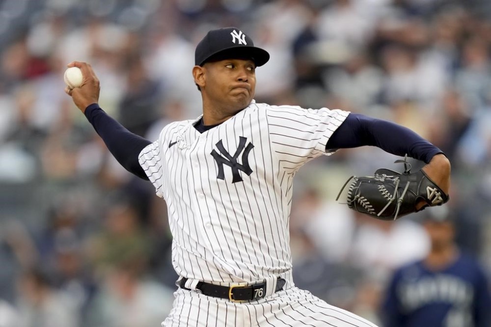 New York Yankees starting pitcher Jhony Brito (76) throws in the first inning of a baseball game against the Seattle Mariners, Wednesday, June 21, 2023, in New York. (AP Photo/John Minchillo)