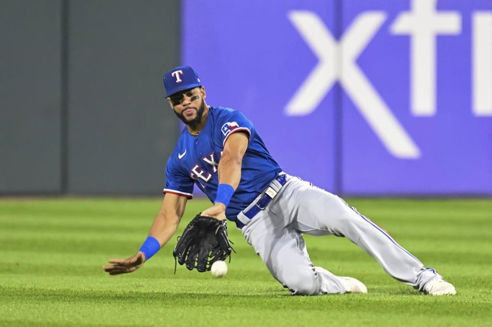 Texas Rangers center fielder Leody Taveras can't catch a double by Chicago White Sox's Clint Frazier during the seventh inning of a baseball game Wednesday, June 21, 2023, in Chicago. (AP Photo/Quinn Harris)