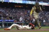 San Francisco Giants' Blake Sabol, bottom, reacts after scoring against San Diego Padres catcher Gary Sanchez during the fifth inning of a baseball game in San Francisco, Wednesday, June 21, 2023. Sabol was initially called out but was ruled safe after the Giants challenged. (AP Photo/Jeff Chiu)