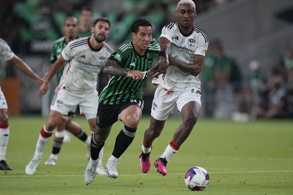 Austin FC forward Sebastian Driussi, center, works the ball past FC Dallas defender Nkosi Tafari, right, during the second half of an MLS soccer match in Austin, Texas, Wednesday, June 21, 2023. (AP Photo/Eric Gay)