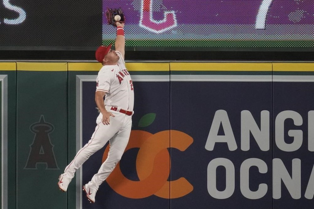 Los Angeles Angels center fielder Mike Trout (27) fails to catch a home run ball hit by Los Angeles Dodgers' Miguel Vargas during the ninth inning of a baseball game in Anaheim, Calif., Wednesday, June 21, 2023. (AP Photo/Ashley Landis)
