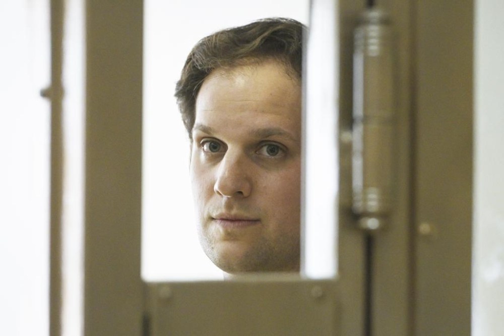 Wall Street Journal reporter Evan Gershkovich stands in a glass cage in a courtroom at the Moscow City Court in Moscow, Russia, Thursday, June 22, 2023. Gershkovich, a Wall Street Journal reporter detained on espionage charges in Russia, appeared in court Thursday to appeal his extended detention. (AP Photo/Dmitry Serebryakov)