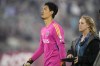 Vancouver Whitecaps goalkeeper Yohei Takaoka heads off the pitch after severe storms in the area forced the delay of the team's MLS soccer match against the Colorado Rapids on Wednesday, June 21, 2023, in Commerce City, Colo. (AP Photo/David Zalubowski)