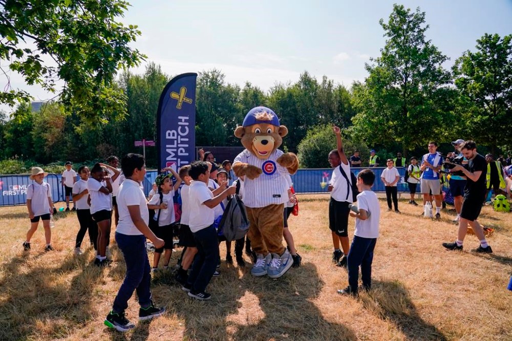 Clark, Chicago Cubs mascot welcomes school kids at the MLB First Pitch Festival, at the Queen Elizabeth Olympic Park, in London, Thursday, June 22, 2023. Britain's relative success at the World Baseball Classic and the upcoming series between the Chicago Cubs and St. Louis Cardinals has increased London's interest about baseball. The sport's governing body says it has seen an uptick in interest among kids. (AP Photo/Alberto Pezzali)