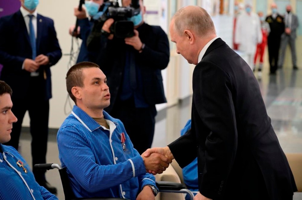 FILE Russian President Vladimir Putin, right, awards a serviceman who participated in a special military operation in Ukraine at the Central Military Hospital named after Alexander Vishnevsky, in Moscow, Russia, Monday, June 12, 2023. Putin has remained silent about harsh criticism of the top military brass from Yevgeny Prigozhin, the maverick millionaire head of the private military contractor Wagner.(Vladimir Astapkovich, Sputnik, Kremlin Pool Photo via AP, File)