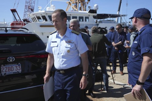 U.S. Coast Guard Rear Adm. John Mauger, commander of the First Coast Guard District, left, steps away from the media at the conclusion of a news conference, Thursday, June 22, 2023, at Coast Guard Base Boston in Boston. The U.S. Navy has confirmed its acoustic sensors detected “an anomaly consistent with an implosion” in the area where the doomed submersible Titan was operating when it lost contact with surface vessels on Sunday. THE CANADIAN PRESS/AP/Steven Senne