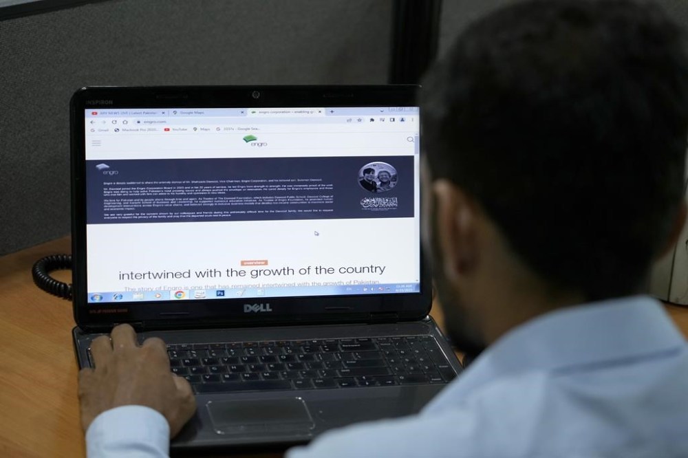 A Pakistani browses an Engro Corporation Limited's website, which shows the picture of its vice chairman of Shahzada Dawood, and his son Suleman Dawood with condolence massage, on a computer, in Islamabad, Pakistan, Friday, June 23, 2023. The missing submersible Titan imploded near the wreckage of the Titanic, killing all five people, Shahzada Dawood, Suleman Dawood, Paul-Henry Nargeolet, Stockton Rush, and Hamish Harding, the U.S. Coast Guard announced on Thursday. (AP Photo/Anjum Naveed)