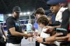 Miami Marlins second baseman Luis Arraez signs autographs before a baseball game against the Toronto Blue Jays, Tuesday, June 20, 2023, in Miami. (AP Photo/Lynne Sladky)
