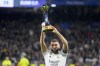 FILE - Real Madrid's Karim Benzema holds up the FIFA Club World Cup trophy prior to a Spanish La Liga soccer match between Real Madrid and Elche CF at the Santiago Bernabeu stadium in Madrid, Spain, Wednesday, Feb. 15, 2023. The United States will host the Club World Cup in 2025, the first time the FIFA tournament will have 32 teams. Real Madrid, Manchester City and Chelsea already earned places as recent Champions League winners for the expanded tournament lineup that is set to test stadiums and operations one year before the 2026 World Cup. (AP Photo/Manu Fernandez, File)