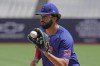 Chicago Cubs' Edwin Rios practices during a training session ahead of the baseball match against St. Louis Cardinals at the MLB World Tour London Series, in London Stadium. (AP Photo/Kin Cheung)