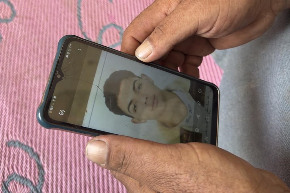 Saleh: Mohammed Saleh, the father of 18-year-old Yahia Saleh, holds a phone with a photo of his son at home in Ibrash, Egypt, Sunday, June 18, 2023. Yahia is one of dozens from the village feared to have drowned after a packed fishing vessel sank off Greece on June 14. There were as many as 750 migrants, including women and children, on board the trawler, which capsized and sank off Greece in one of the deepest parts of the Mediterranean Sea instead of docking in Italy. (AP Photo)
