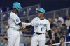 Miami Marlins' Jesus Sanchez, left, is congratulated by first base/outfield coach Jon Jay (11) after Sanchez hit a single scoring Luis Arraez during the first inning of a baseball game against the Pittsburgh Pirates, Friday, June 23, 2023, in Miami. (AP Photo/Wilfredo Lee)