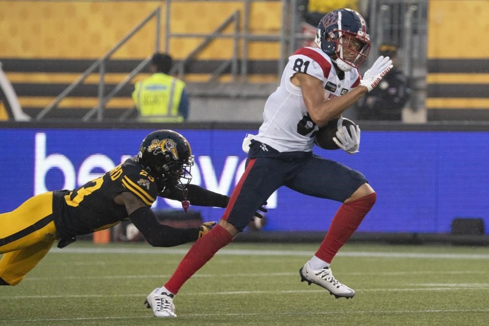 Montreal Alouettes wide receiver Austin Mack (81) breaks free from Hamilton Tiger Cats defensive back Richard Leonard (23) during first half CFL football game action in Hamilton, Ont. on Friday, June 23, 2023. THE CANADIAN PRESS/Peter Power