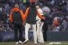 San Francisco Giants' Mike Yastrzemski, right, walks off the field with manager Gabe Kapler, middle, and a trainer during the fifth inning of the team's baseball game against the San Diego Padres in San Francisco, Wednesday, June 21, 2023. (AP Photo/Jeff Chiu)