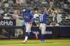 Texas Rangers' Adolis Garcia, left, celebrates as he runs the bases after hitting a go-ahead two-run home run off New York Yankees relief pitcher Michael King (not shown) in the 10th inning of a baseball game, Friday, June 23, 2023, in New York. (AP Photo/John Minchillo)