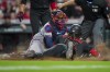 Cincinnati Reds' Elly De La Cruz, right, is tagged out by Atlanta Braves' Travis d'Arnaud, left, while attempting to steal home plate during the sixth inning of a baseball game in Cincinnati, Friday, June 23, 2023. (AP Photo/Aaron Doster)