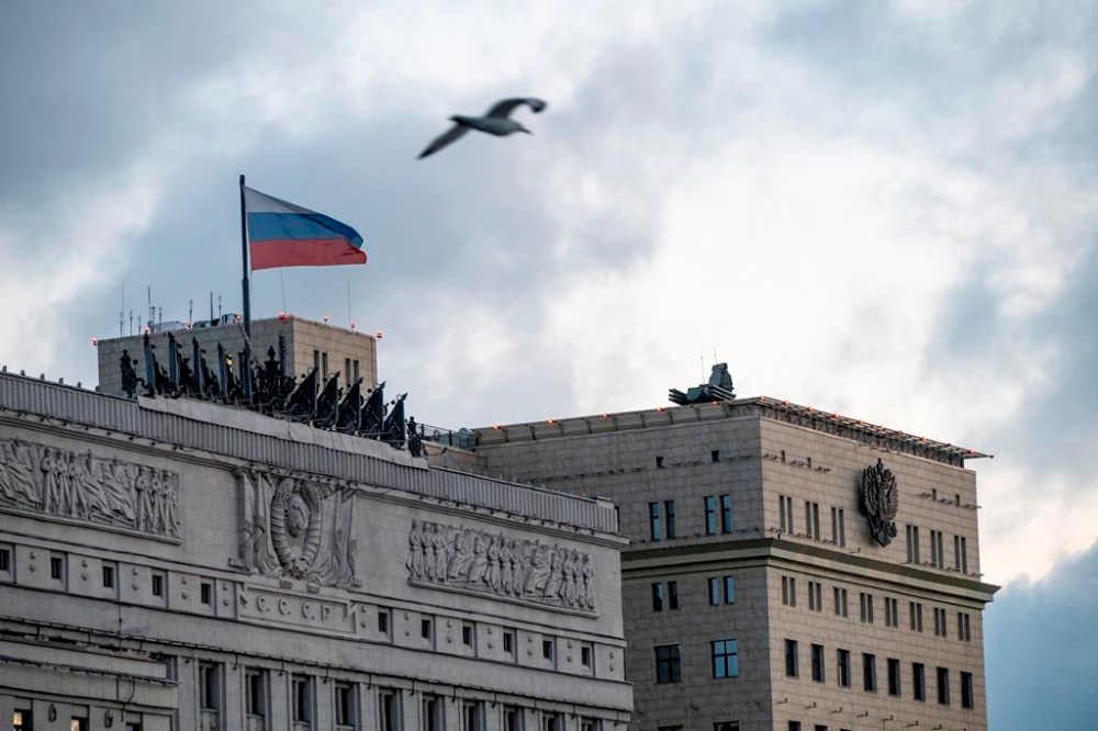 A bird flies over the building of the Russian Defense Ministry with anti-aircraft artillery systems atop the roof in Moscow, early Saturday, June 24, 2023. (AP Photo)
