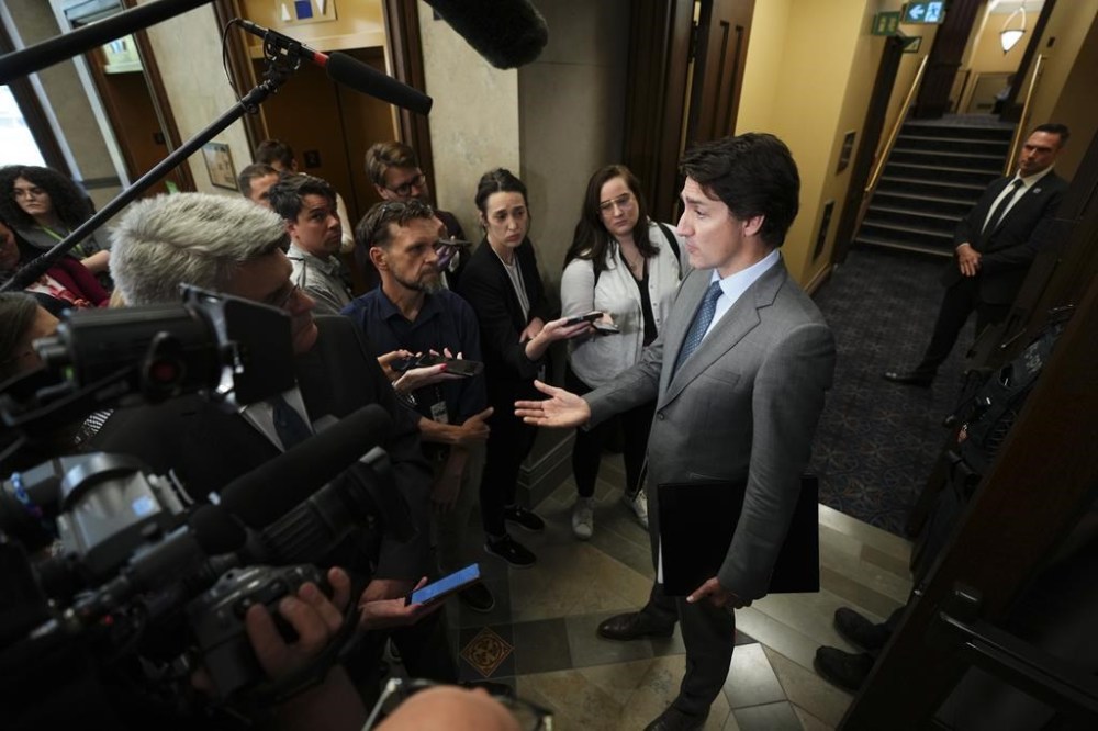 Prime Minister Justin Trudeau speaks to reporters in the foyer of the House of Commons on Parliament Hill in Ottawa on Wednesday, June 21, 2023. Trudeau says Canada's incident response group is meeting Saturday to discuss the latest developments in Russia. THE CANADIAN PRESS/Sean Kilpatrick