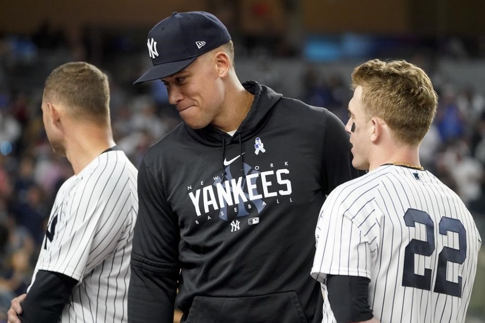 New York Yankees outfielder Aaron Judge, left, greets center fielder Harrison Bader (22) during the seventh inning stretch of a baseball game against the Seattle Mariners, Tuesday, June 20, 2023, in New York. (AP Photo/John Minchillo)
