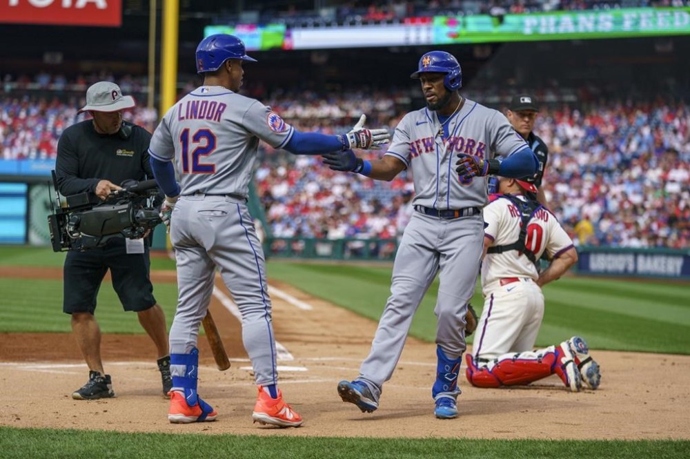 New York Mets' Starling Marte, center left, celebrates after his home run with Francisco Lindor, center right, during a baseball game against the Philadelphia Phillies, Saturday, June 24, 2023, in Philadelphia. (AP Photo/Chris Szagola)