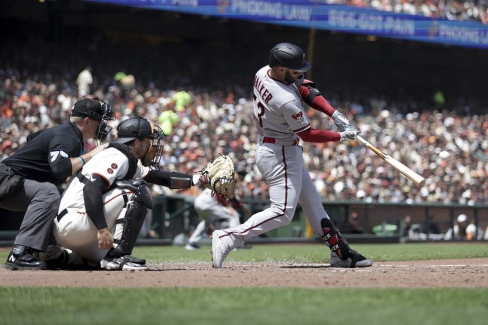 Arizona Diamondbacks' Christian Walker hits a three-run double in front of San Francisco Giants catcher Patrick Bailey during the fifth inning of a baseball game in San Francisco, Saturday, June 24, 2023. (AP Photo/Jed Jacobsohn)