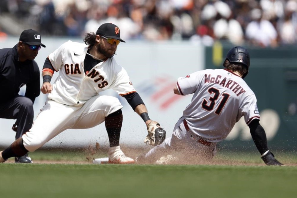 Arizona Diamondbacks' Jake McCarthy (31) steals second base against San Francisco Giants shortstop Brandon Crawford during the fifth inning of a baseball game in San Francisco, Saturday, June 24, 2023. (AP Photo/Jed Jacobsohn)