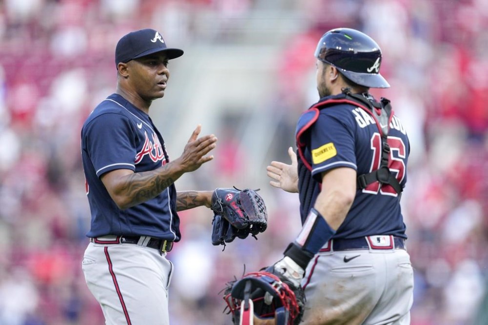 Atlanta Braves relief pitcher Raisel Iglesias, left, celebrates with catcher Travis d'Arnaud (16) after a baseball game against the Cincinnati Reds, Saturday, June 24, 2023, in Cincinnati. (AP Photo/Jeff Dean)