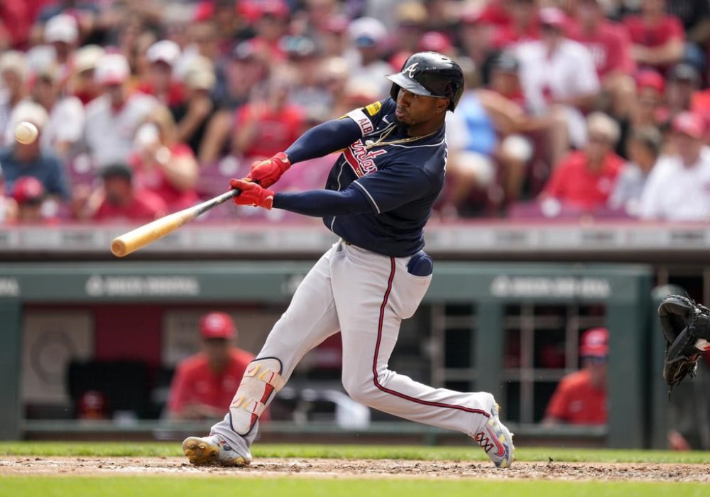 Atlanta Braves' Ozzie Albies hits a solo home run against the Cincinnati Reds in the third inning of a baseball game Saturday, June 24, 2023, in Cincinnati. (AP Photo/Jeff Dean)