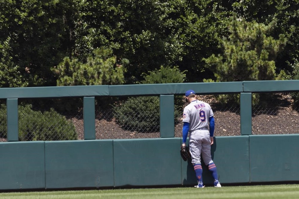 New York Mets center fielder Brandon Nimmo (9) watches a home run ball from Philadelphia Phillies' Trea Turner go over the fence during the first inning of a baseball game, Sunday, June 25, 2023, in Philadelphia. (AP Photo/Laurence Kesterson)