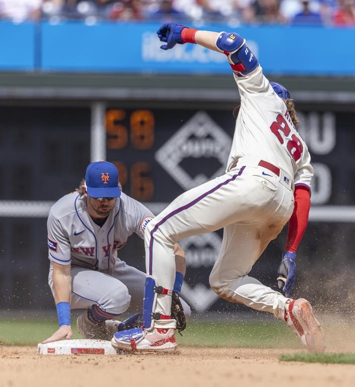 Philadelphia Phillies' Alec Bohm (28) is out at second as New York Mets second baseman Jeff McNeil (1) makes the tag during the seventh inning of a baseball game, Sunday, June 25, 2023, in Philadelphia. (AP Photo/Laurence Kesterson)