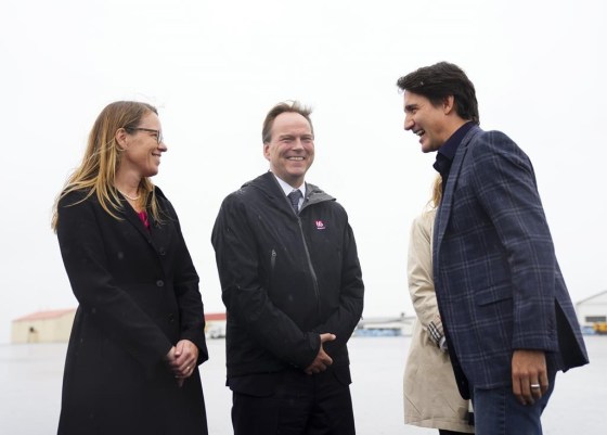 Prime Minister Justin Trudeau is greeted by Hlynur Gudjonsson, ambassador of Iceland to Canada, and Jeannette Menzies, ambassador of Canada to Iceland, as he arrives in Keflavik, Iceland, on Sunday. (Sean Kilpatrick / The Canadian Press)