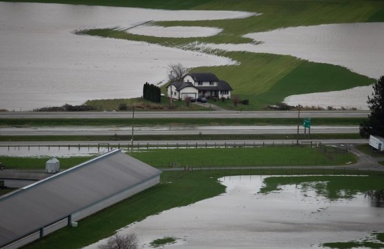 A house sits on high ground among flooded farmland in Abbotsford, B.C., in 2021. (Darryl Dyck / The Canadian Press files)