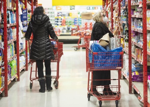 People shop in a grocery store in Montreal, Wednesday, Nov. 16, 2022. The Competition Bureau report suggests rules to force grocers to introduce unit pricing so shoppers can compare products more easily. THE CANADIAN PRESS/Graham Hughes