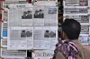 A man looks at morning newspapers as some papers published an ad of condolence massages for two victims of Titan submersible incident, Shahzada Dawood and his son Suleman Dawood, by their family and firm, at a roadside stall, in Islamabad, Pakistan, Tuesday, June 27, 2023. As an international group of agencies investigates why the Titan submersible imploded while carrying five people to the Titanic wreckage, U.S. maritime officials say they'll issue a report aimed at improving the safety of submersibles worldwide. (AP Photo/Anjum Naveed)