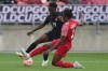 Canada's Moise Bambino (left) battles with Guadeloupe's Andreaw Gravillon during first half CONCACAF Gold Cup group stage action in Toronto, on Tuesday, June 27, 2023.THE CANADIAN PRESS/Chris Young