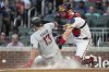 Minnesota Twins' Joey Gallo (13) beats the throw to Atlanta Braves catcher Sean Murphy to score on an Edouard Julien sacrifice fly during the fourth inning of a baseball game Tuesday, June 27, 2023, in Atlanta. (AP Photo/John Bazemore)