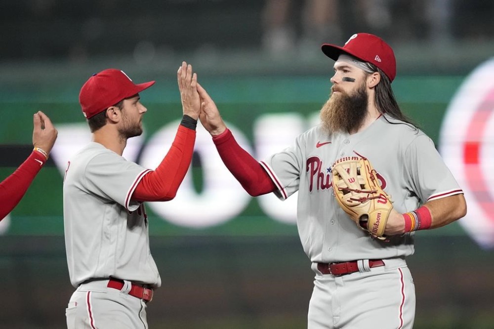 Philadelphia Phillies shortstop Trea Turner, left, and center fielder Brandon Marsh celebrate the team's 5-1 win over the Chicago Cubs in a baseball game Tuesday, June 27, 2023, in Chicago. (AP Photo/Charles Rex Arbogast)