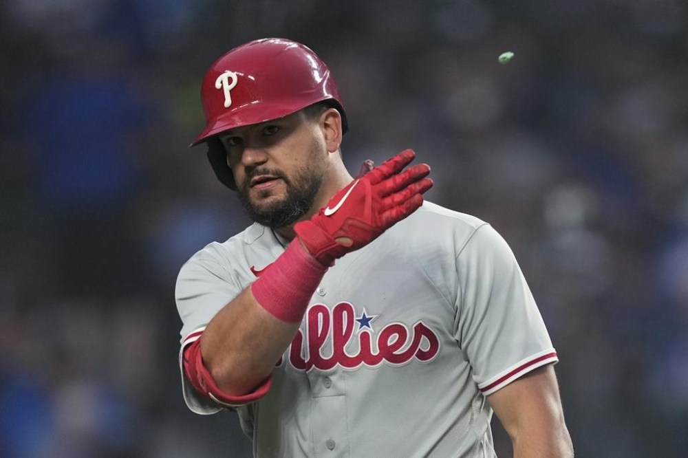Philadelphia Phillies' Kyle Schwarber spits out his gum and bats it away after striking out during the fifth inning of the team's baseball game against the Chicago Cubs on Tuesday, June 27, 2023, in Chicago. (AP Photo/Charles Rex Arbogast)
