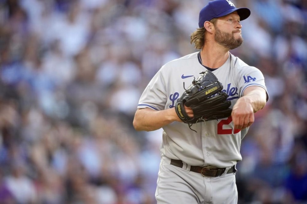 Los Angeles Dodgers starting pitcher Clayton Kershaw throws to first base to put out Colorado Rockies' C.J. Cron in the second inning of a baseball game Tuesday, June 27, 2023, in Denver. (AP Photo/David Zalubowski)